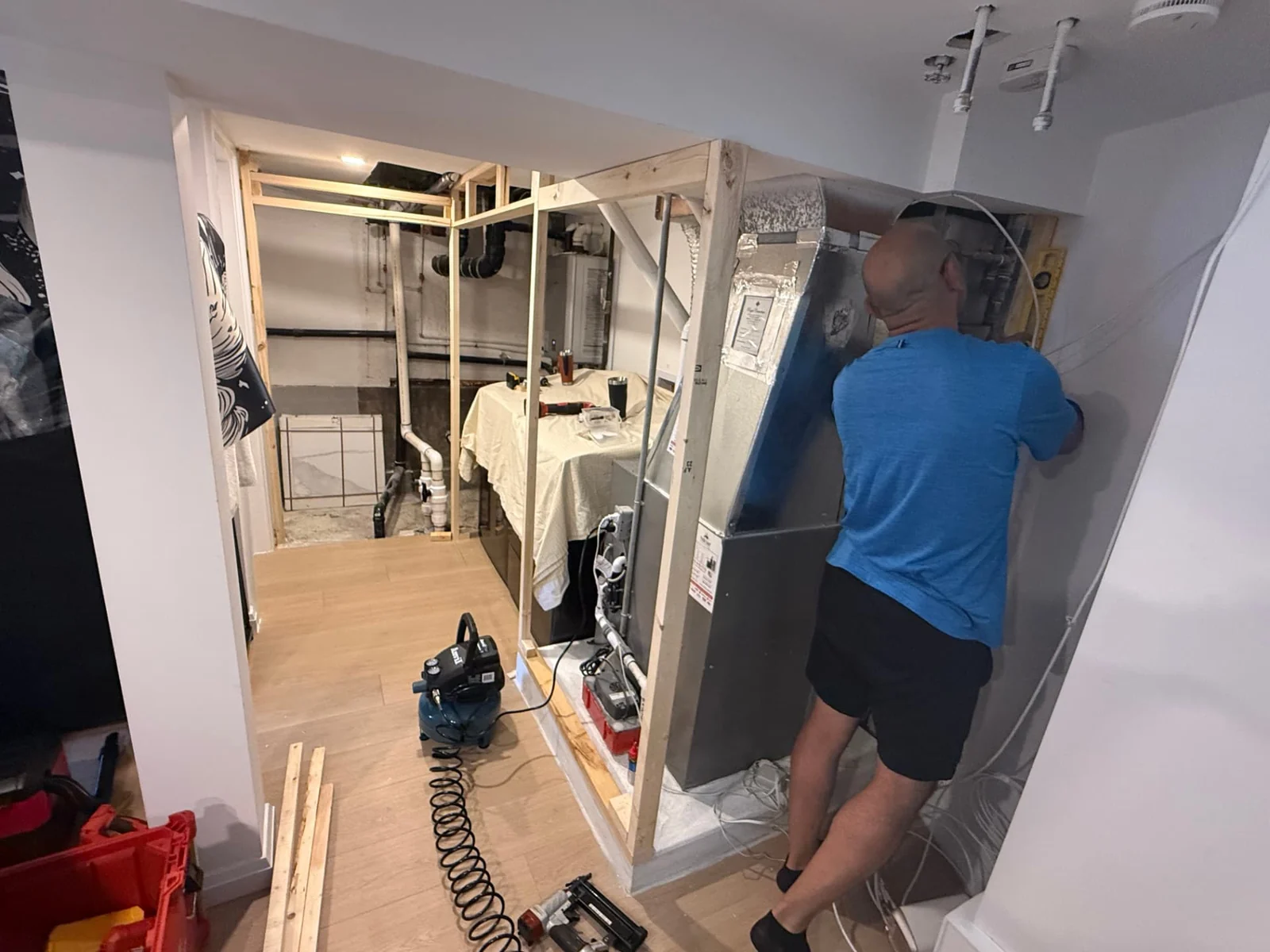 During — new framing built around the basement utility area.
