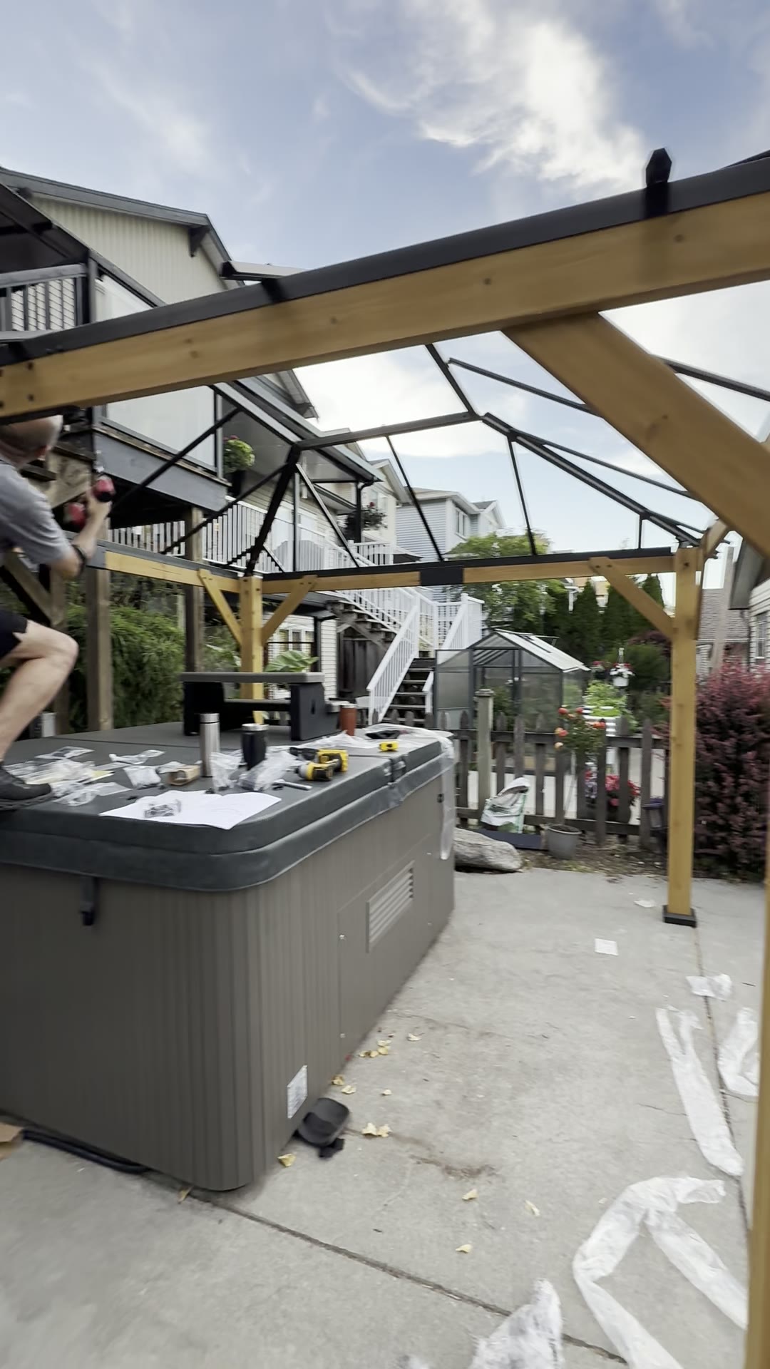 During — roof beams and pergola-style framing being assembled.