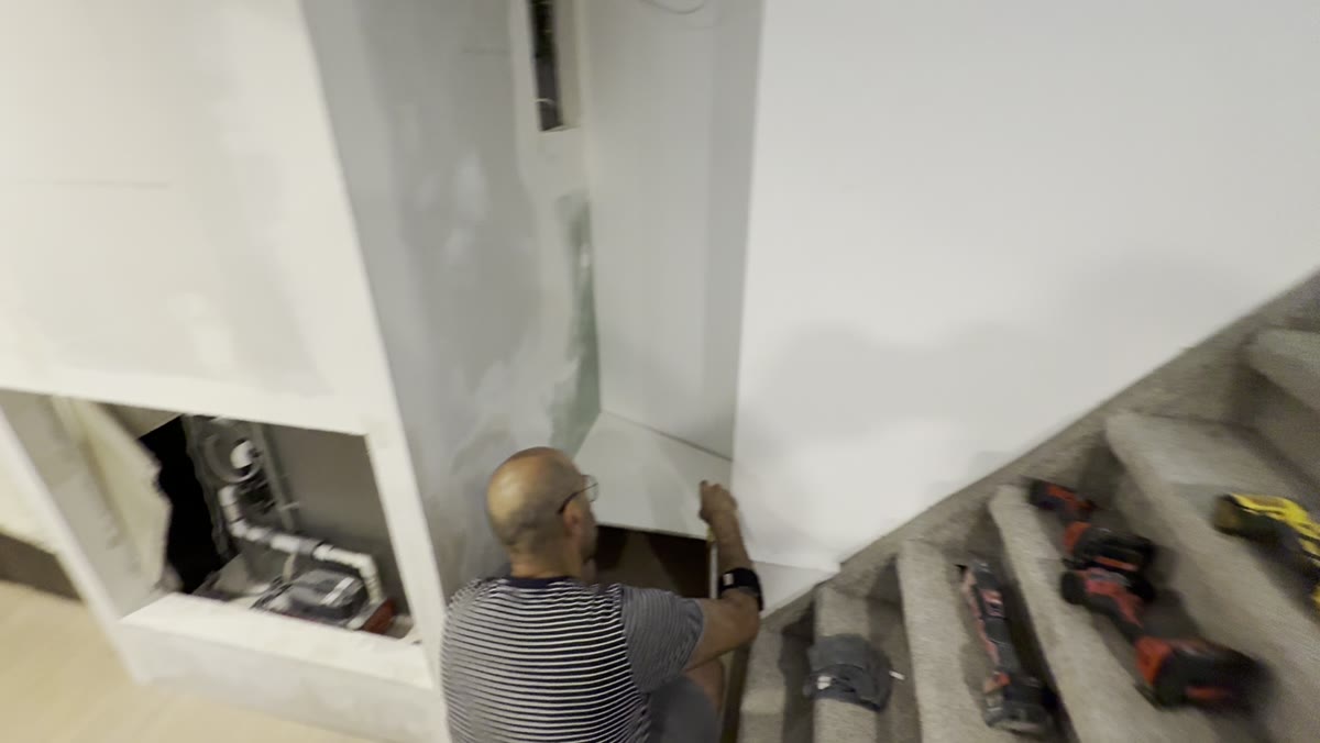 During — drywall, repairs, and finishing work progressing through the basement.