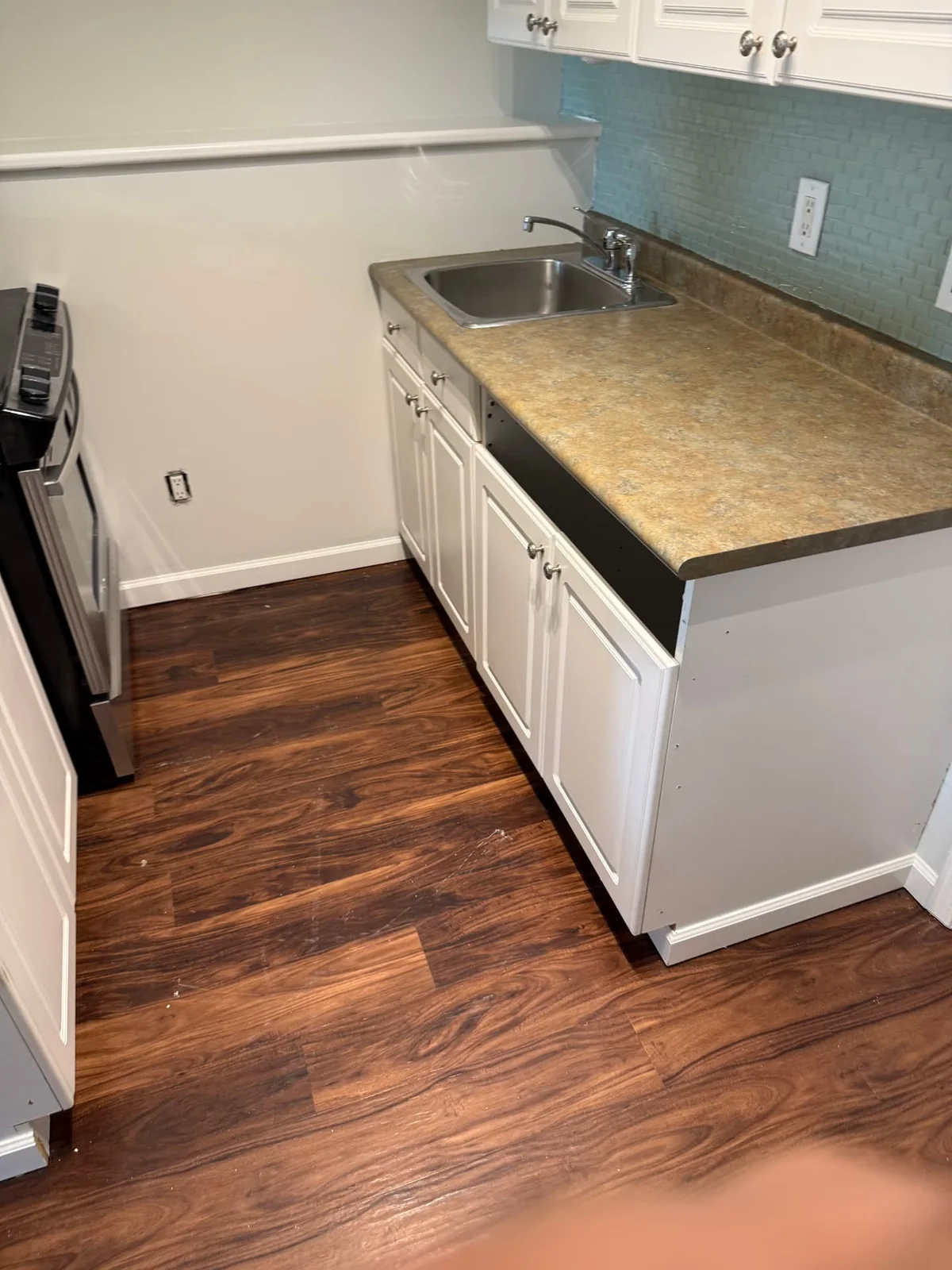 Before — original sink cabinet and countertop.
