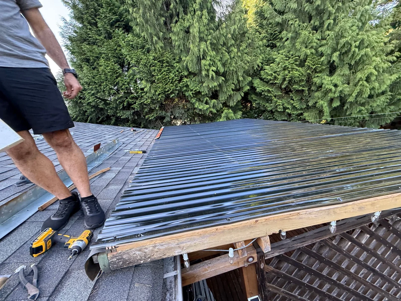 During — new weather-resistant roof panels being aligned and secured.