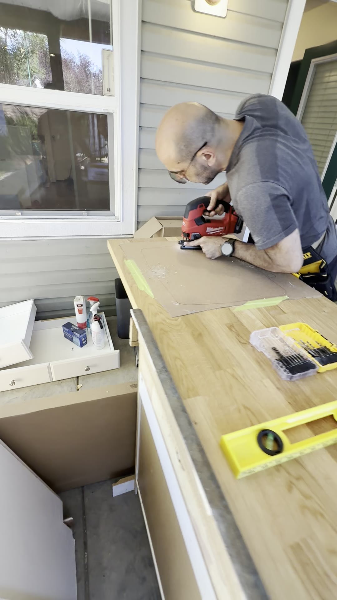 During — custom wood countertop being measured and cut.