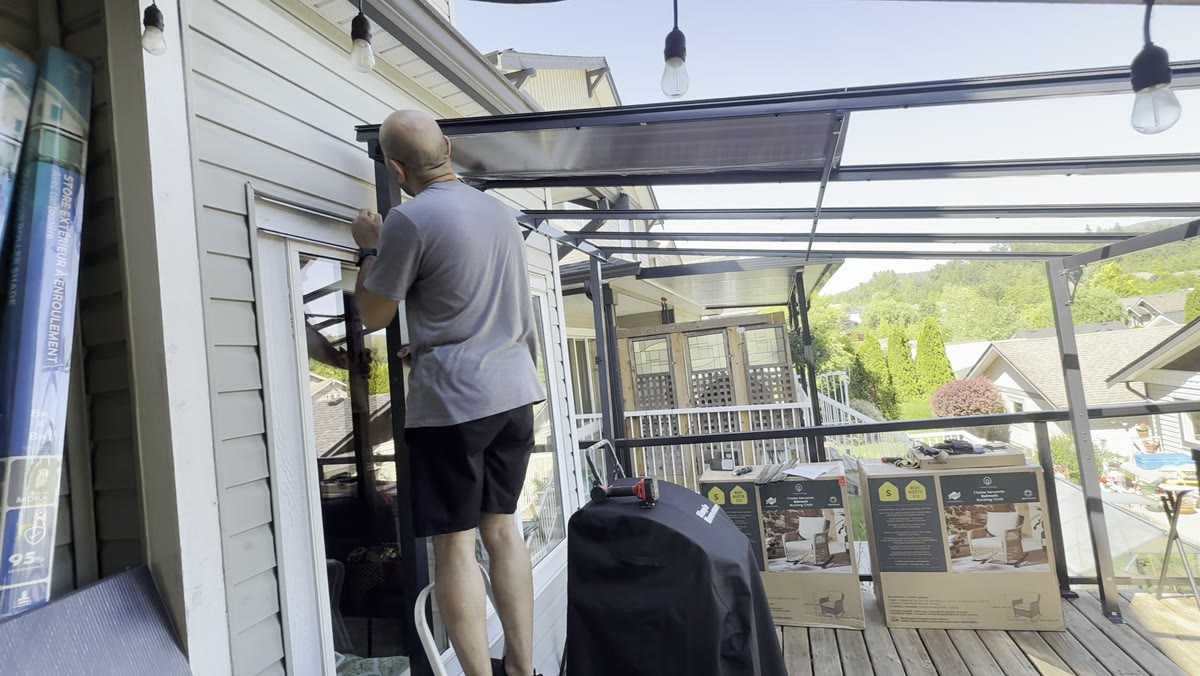 During — metal roof framework installed across the outdoor living space.